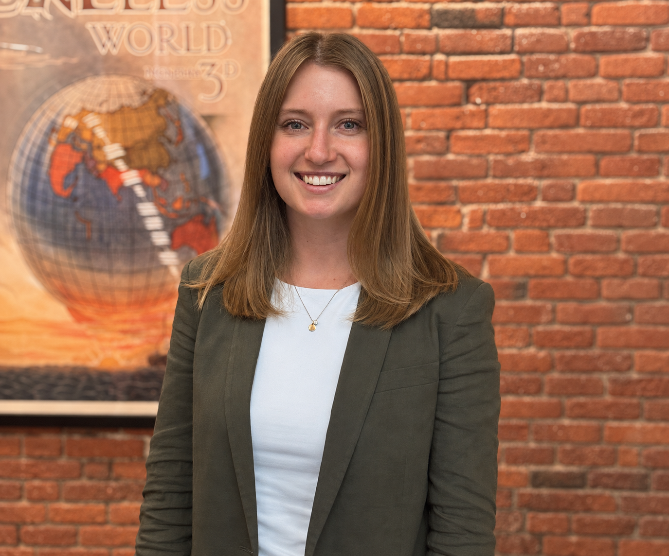 executive standing in front of brick wall